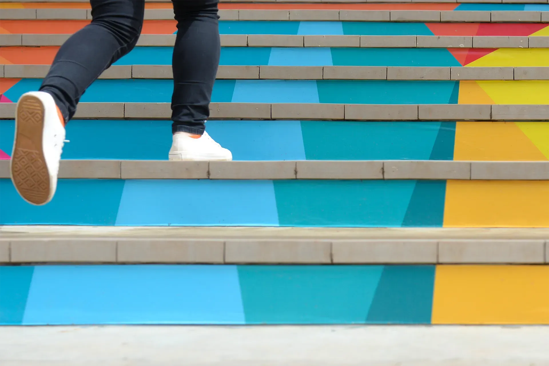 Feet running up a set of stairs